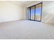 Spacious bedroom with neutral carpet and a sliding glass door to a balcony at 1 Easy St # 6, Carefree, AZ 85377