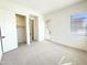 Well-lit bedroom features a large closet, neutral carpet, and an exterior door leading to outdoor space at 1 Easy St # 6, Carefree, AZ 85377