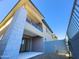 Modern two-story home featuring a balcony with glass railing and a stone accent wall at 1 Easy St # 6, Carefree, AZ 85377