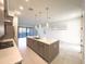 Kitchen features an island with sink, stainless steel appliances, modern pendants, and access to the patio through sliding glass doors at 1 Easy St # 6, Carefree, AZ 85377
