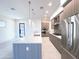 Modern kitchen features stainless steel appliances, gray cabinets, a gas cooktop, and a large quartz countertop island at 1 Easy St # 6, Carefree, AZ 85377