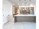 Open kitchen with gray cabinets, stainless steel appliances, a tile backsplash, and an island with a quartz countertop at 1 Easy St # 6, Carefree, AZ 85377