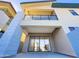 View of the patio, with sliding glass doors to the living room, and a balcony above with glass railings at 1 Easy St # 6, Carefree, AZ 85377