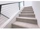 Carpeted stairs with modern metal railing ascend to the upper level at 1 Easy St # 6, Carefree, AZ 85377