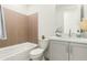 Bathroom featuring a bathtub, vanity with sink, and tiled accent wall at 1 Easy St # 7, Carefree, AZ 85377