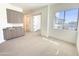 Bright bedroom boasts neutral tones, carpet, large window, and custom storage cabinets at 1 Easy St # 7, Carefree, AZ 85377