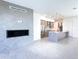 Open concept living room and kitchen with modern fireplace and tile flooring at 1 Easy St # 7, Carefree, AZ 85377