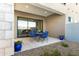 A cozy patio featuring elegant stone walls, inviting blue chairs, and a stylish outdoor table set at 1 Easy St # 7, Carefree, AZ 85377