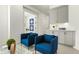 Relaxing seating area with blue armchairs, custom cabinets, and stylish decor at 1 Easy St # 7, Carefree, AZ 85377