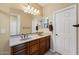 A dual sink bathroom featuring bright lighting and granite countertop over wood cabinetry at 12915 W Lone Tree Trl, Peoria, AZ 85383