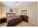 A neutral-toned bedroom featuring warm decor with stylish furnishings and tile flooring at 12915 W Lone Tree Trl, Peoria, AZ 85383