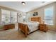 A comfortable bedroom featuring bright natural light from dual windows and warm interior design at 12915 W Lone Tree Trl, Peoria, AZ 85383