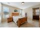 A neutral-toned bedroom featuring stylish decor, a comfortable bed, and plenty of natural light at 12915 W Lone Tree Trl, Peoria, AZ 85383