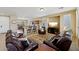 Inviting living room with plush leather seating and an open layout into the kitchen at 12915 W Lone Tree Trl, Peoria, AZ 85383