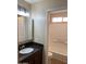 Bathroom featuring dark cabinets with granite countertop and a separate tiled shower tub combo at 14145 N 92Nd St # 2004, Scottsdale, AZ 85260