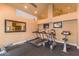 Well-equipped fitness center with treadmills, elliptical machines, a mirror, and televisions for residents at 14145 N 92Nd St # 2004, Scottsdale, AZ 85260