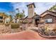 Entrance to the Residence Center with stone accents, desert plants, and a tower feature under a bright sky at 14145 N 92Nd St # 2004, Scottsdale, AZ 85260