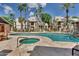 Community swimming pool and hot tub surrounded by lounge chairs and palm trees, with buildings in the background at 14145 N 92Nd St # 2004, Scottsdale, AZ 85260