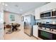 Eat-in kitchen dining area with stainless appliances, bright, and airy at 14941 W Hackamore Dr, Surprise, AZ 85387