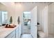 Clean bathroom featuring double sinks, a toilet, and an open door leading to a bedroom, creating a cohesive living space at 15033 W Hackamore Dr, Surprise, AZ 85387