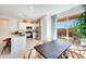 Well-lit kitchen and dining area featuring stainless steel appliances, a quartz countertop, and a seamless transition to the patio at 15033 W Hackamore Dr, Surprise, AZ 85387