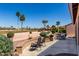 Relaxing backyard seating area with desert landscaping and scenic views of the golf course at 15696 W Roanoke Ave, Goodyear, AZ 85395