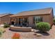 Large backyard with multiple seating areas, desert landscaping, and view of the golf course at 15696 W Roanoke Ave, Goodyear, AZ 85395