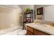 Bathroom featuring a shower with glass doors, modern vanity, and a decorative plant at 15696 W Roanoke Ave, Goodyear, AZ 85395