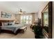 Relax in this bedroom with a ceiling fan, plantation shutters, and an en-suite bathroom at 15696 W Roanoke Ave, Goodyear, AZ 85395