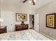 Bedroom with decorative dresser, framed artwork, and an open door to the rest of the home at 15696 W Roanoke Ave, Goodyear, AZ 85395