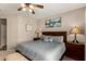 This bedroom features a ceiling fan, a dresser, and carpeted floors at 15696 W Roanoke Ave, Goodyear, AZ 85395