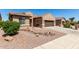 Charming home with desert landscaping, featuring a two car garage and neutral color scheme at 15696 W Roanoke Ave, Goodyear, AZ 85395