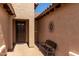 Front porch featuring seating and a decorative sunburst wall hanging at 15696 W Roanoke Ave, Goodyear, AZ 85395