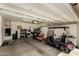 Garage featuring a motorcycle, golf cart, overhead lighting, and wall storage at 15696 W Roanoke Ave, Goodyear, AZ 85395