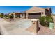 Home exterior featuring two-car garage, desert landscaping and charming mailbox at 15696 W Roanoke Ave, Goodyear, AZ 85395