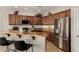 This kitchen features granite countertops, stainless steel appliances, and a breakfast bar at 15696 W Roanoke Ave, Goodyear, AZ 85395