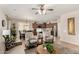 Open living room with tile floors offering seamless flow to the kitchen and dining area at 15696 W Roanoke Ave, Goodyear, AZ 85395