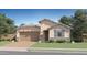 Inviting single-story home featuring a 2-car garage, stone accents, neutral paint, and well-manicured landscaping at 15815 W Kendall St, Goodyear, AZ 85338