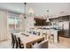 Bright and airy dining area and kitchen boasting modern lighting, neutral tones, and plenty of seating at 15815 W Kendall St, Goodyear, AZ 85338