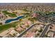 Aerial view of the home with the red star on the roof in a community near a golf course and multiple lakes at 16100 W Galleria Ln, Surprise, AZ 85374