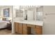 Bathroom featuring a single sink vanity, tile floors, and a decorative mirror at 16100 W Galleria Ln, Surprise, AZ 85374