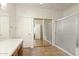 Bathroom featuring a mirrored shower, double closets, tile floor, and neutral colors at 16100 W Galleria Ln, Surprise, AZ 85374