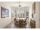 Bright breakfast nook featuring a round table, four chairs, bay windows with plantation shutters, and tile flooring at 16100 W Galleria Ln, Surprise, AZ 85374