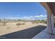 View of a golf course from a covered patio with two chairs, ideal for relaxing and enjoying the lush green landscape at 16100 W Galleria Ln, Surprise, AZ 85374