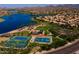 Aerial view of Estrella community showcasing lake, green spaces, and residential homes at 17975 W Agave Rd, Goodyear, AZ 85338