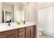 Bathroom featuring a double sink vanity, tiled flooring, and a shower with a curtain at 17975 W Agave Rd, Goodyear, AZ 85338