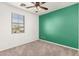 This bedroom features a ceiling fan, neutral carpet, and a window that provides natural light at 17975 W Agave Rd, Goodyear, AZ 85338