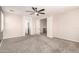 Large bedroom with plush carpet flooring, white trim, and an opening to a connecting hallway at 17975 W Agave Rd, Goodyear, AZ 85338