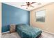 Cozy bedroom with ceiling fan, comfortable bed, and natural light from the window at 17975 W Agave Rd, Goodyear, AZ 85338