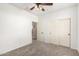 This bedroom features a ceiling fan, neutral carpet and a closet with sliding doors at 17975 W Agave Rd, Goodyear, AZ 85338